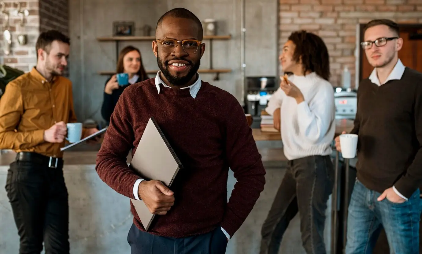 Front-facing view of smiling people meeting over coffee.