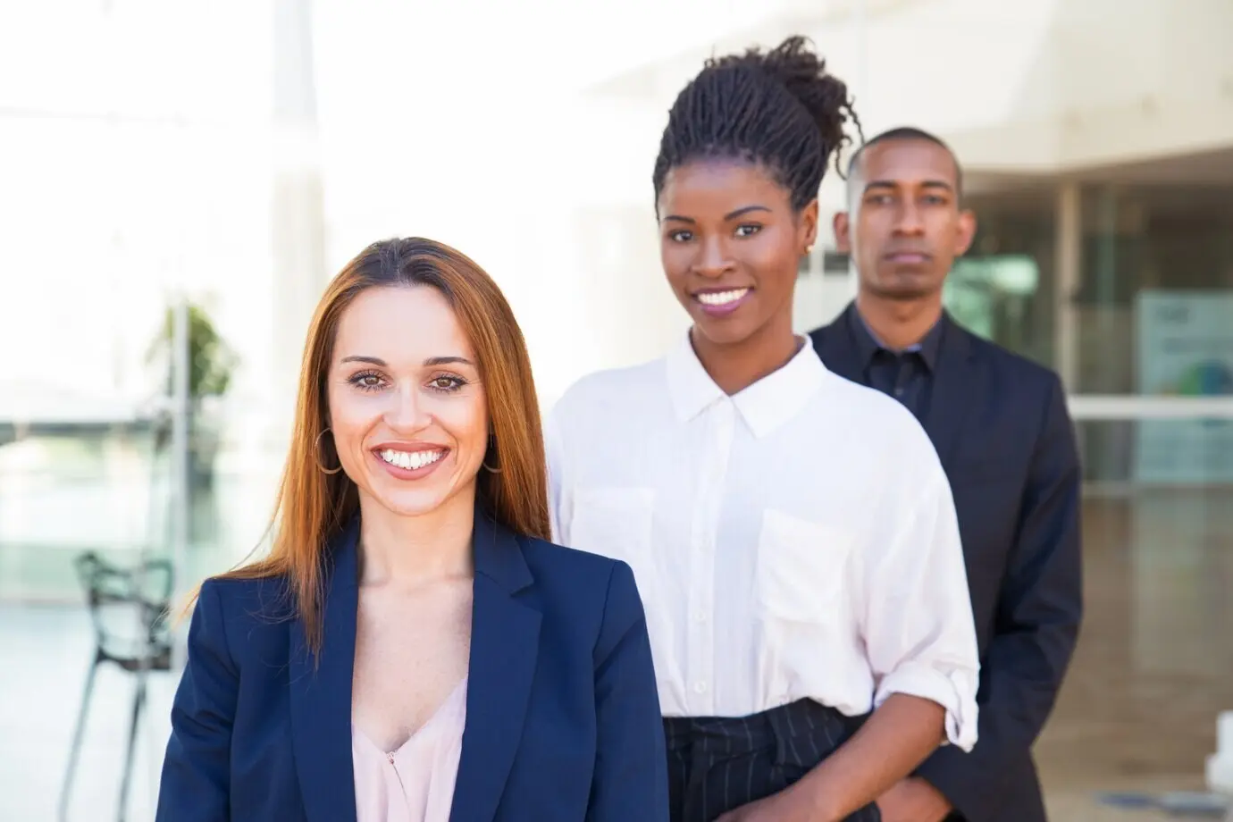 Smiling business professionals posing indoors