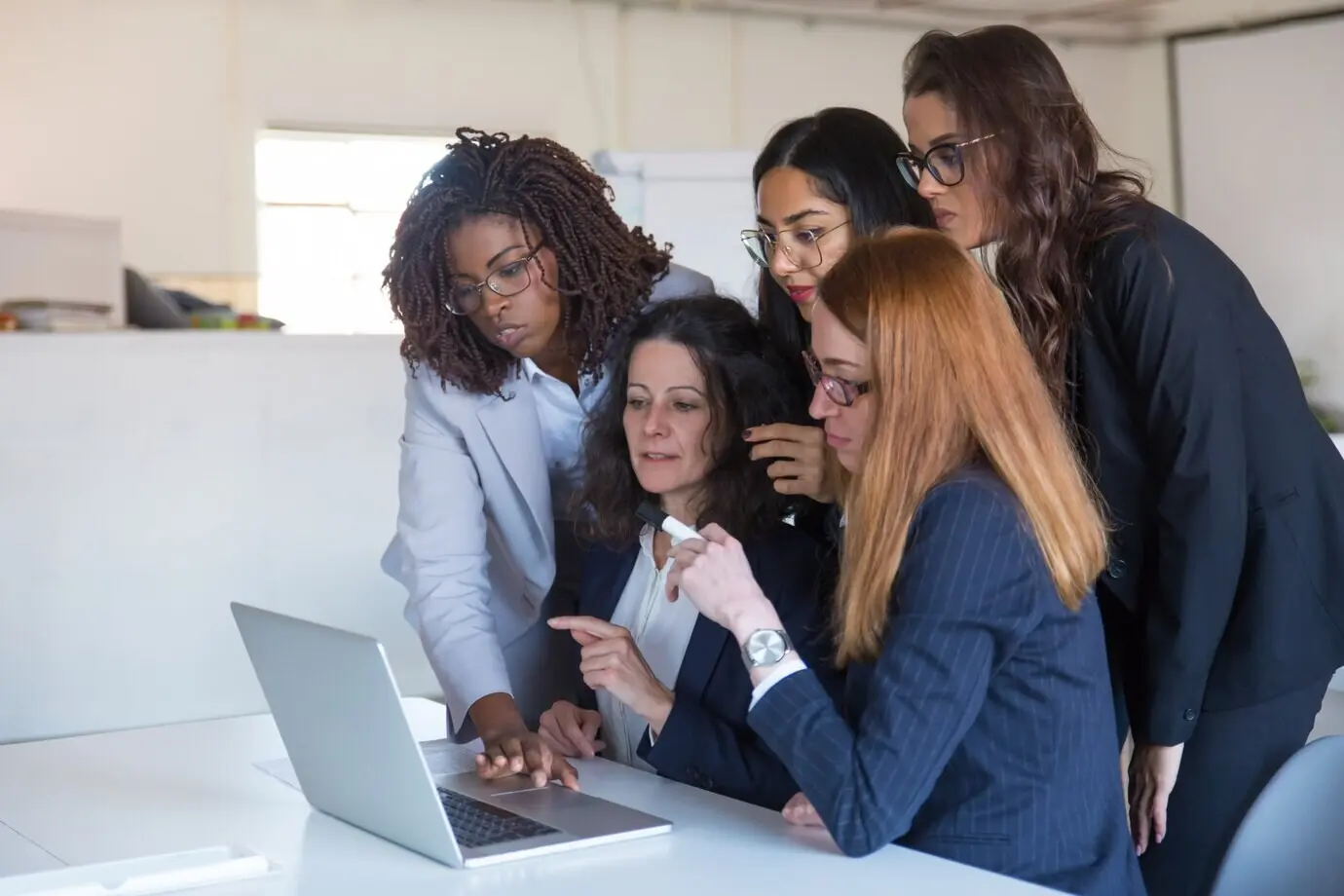 Businesswomen discussing a project at a laptop computer